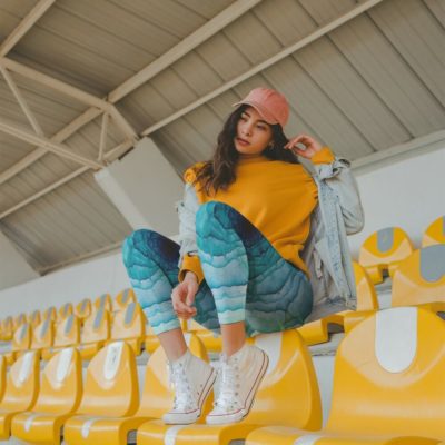 mockup-of-a-girl-wearing-ice-rose-fractal-yoga-leggings-while-sitting-over-yellow-seats-in-a-stadium mockup-of-a-girl-wearing-ice-rose-fractal-yoga-leggings-while-sitting-over-yellow-seats-in-a-stadium